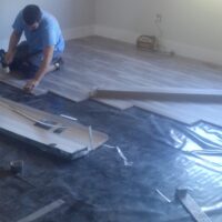 man installing vct flooring