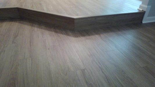 waterproof flooring job with custom step down family room