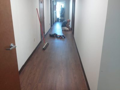 men working hallway flooring