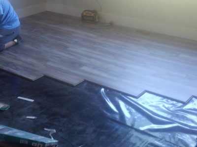 man installing flooring